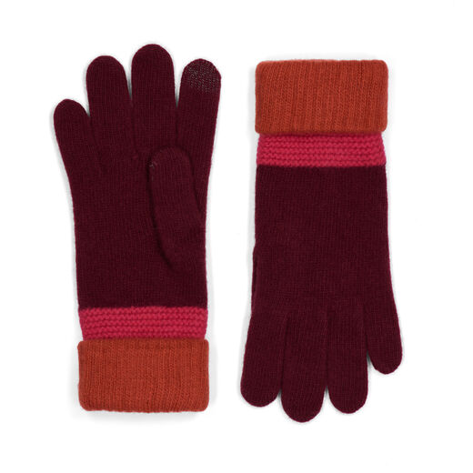 A pair of winter gloves in dark purple wool, with a bright red and magenta cuff.